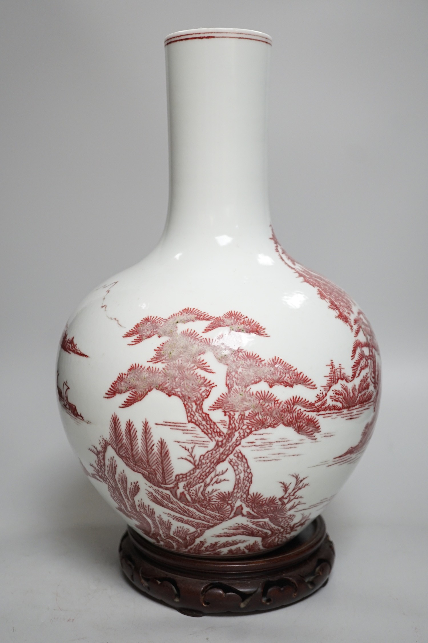 A large Chinese underglaze copper read landscape vase on hardwood stand, 40cm total